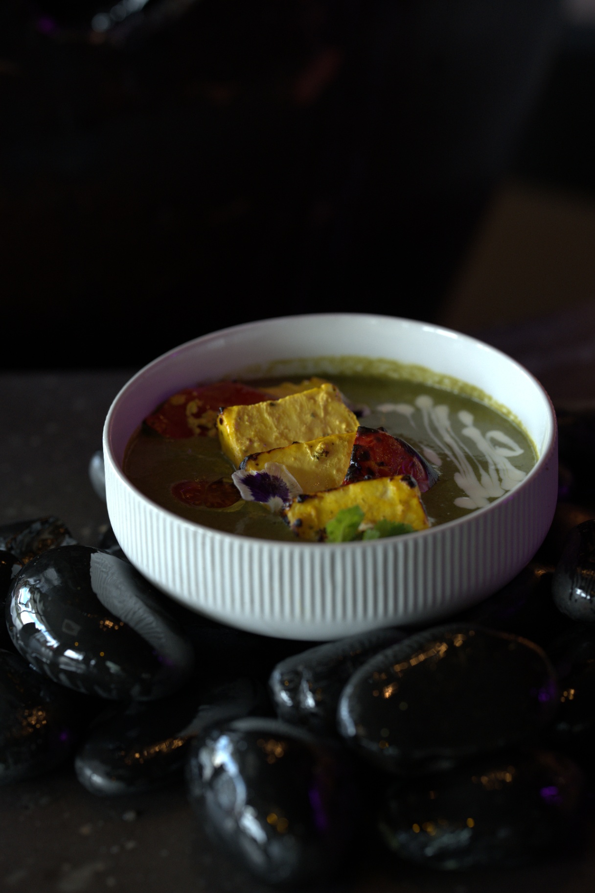 Haryali paneer tikka on polished black stones