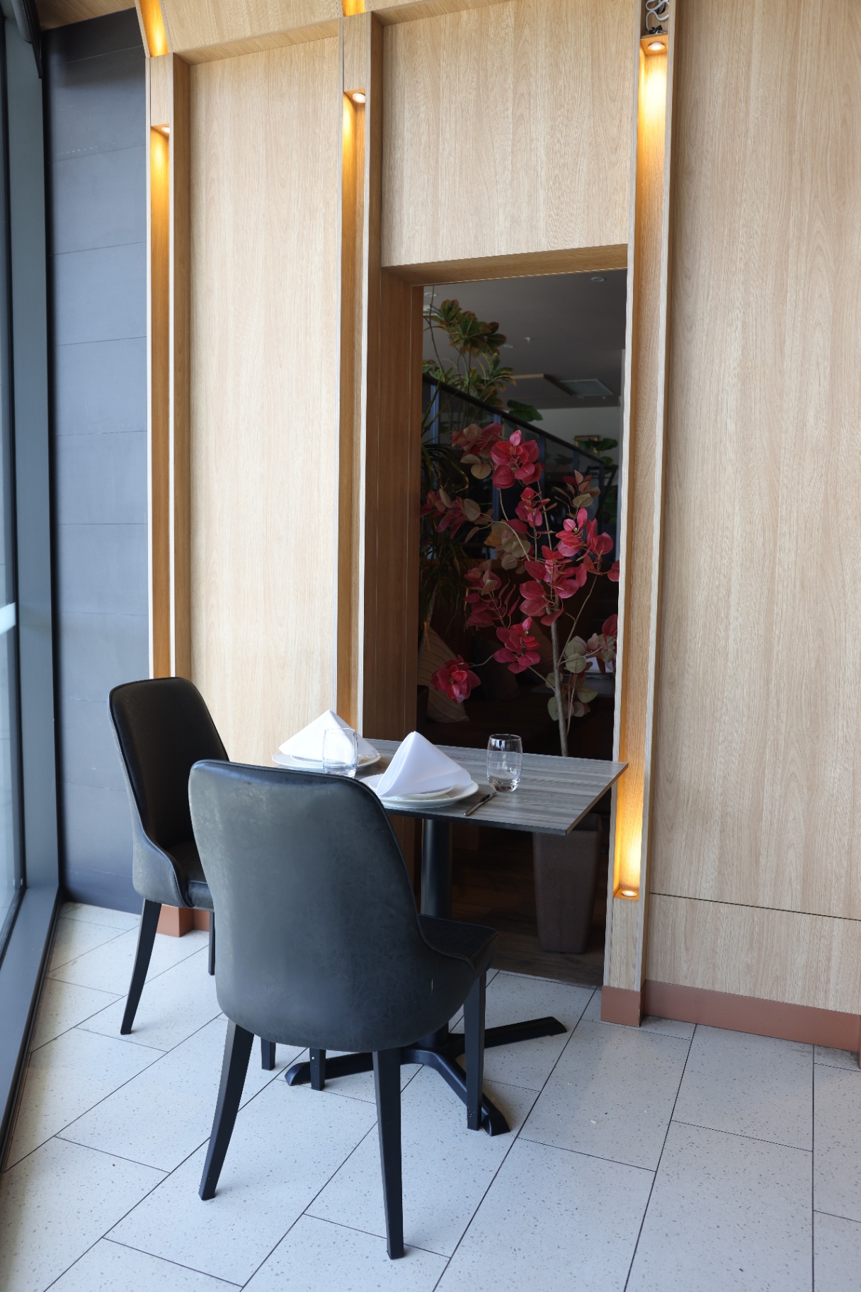 Intimate window-side table for two at Stonewater