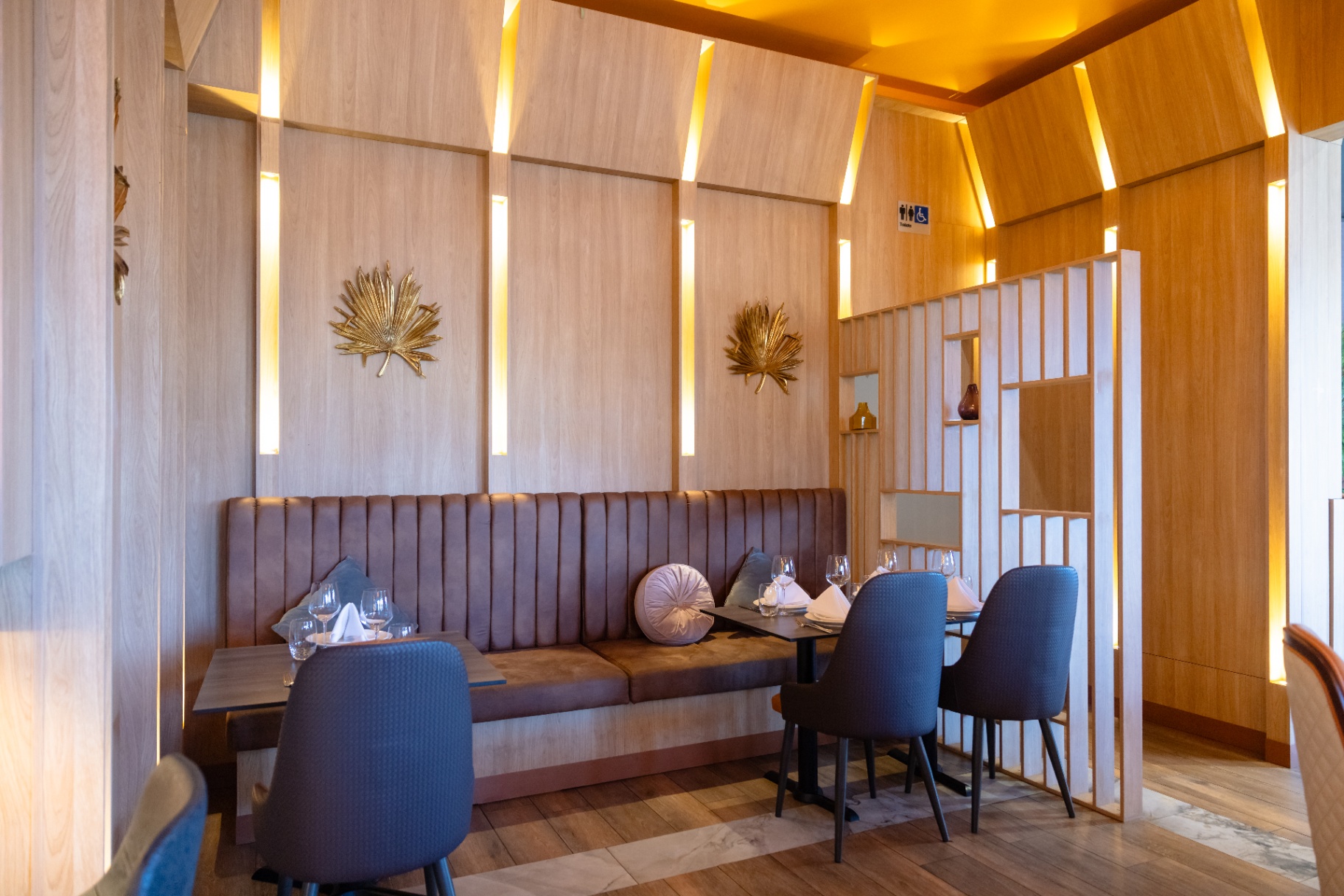 Banquette seating with gold palm details