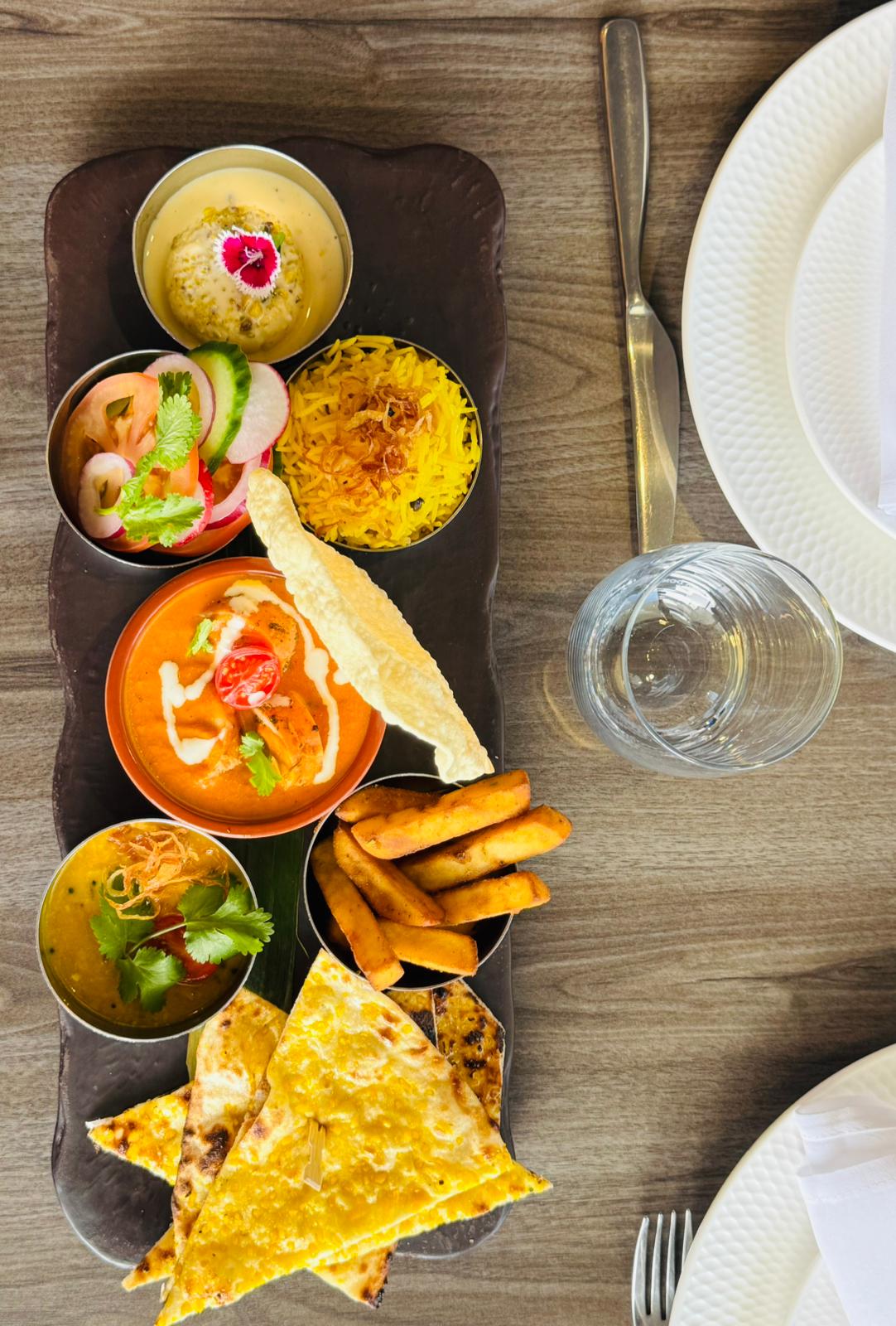 Signature thali platter with curries, rice and naan