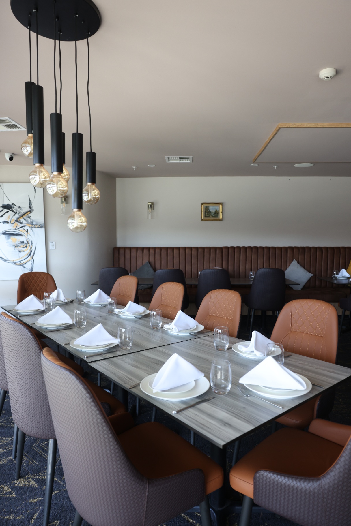 Private dining table set beneath pendant lights