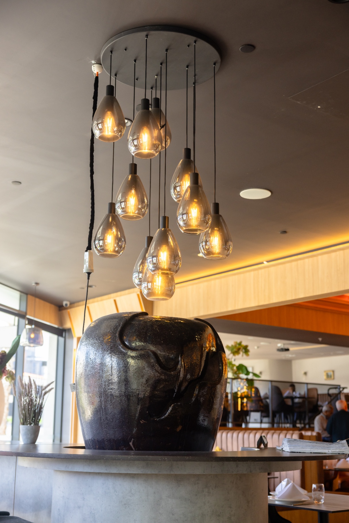 Pendant cluster above the host stand