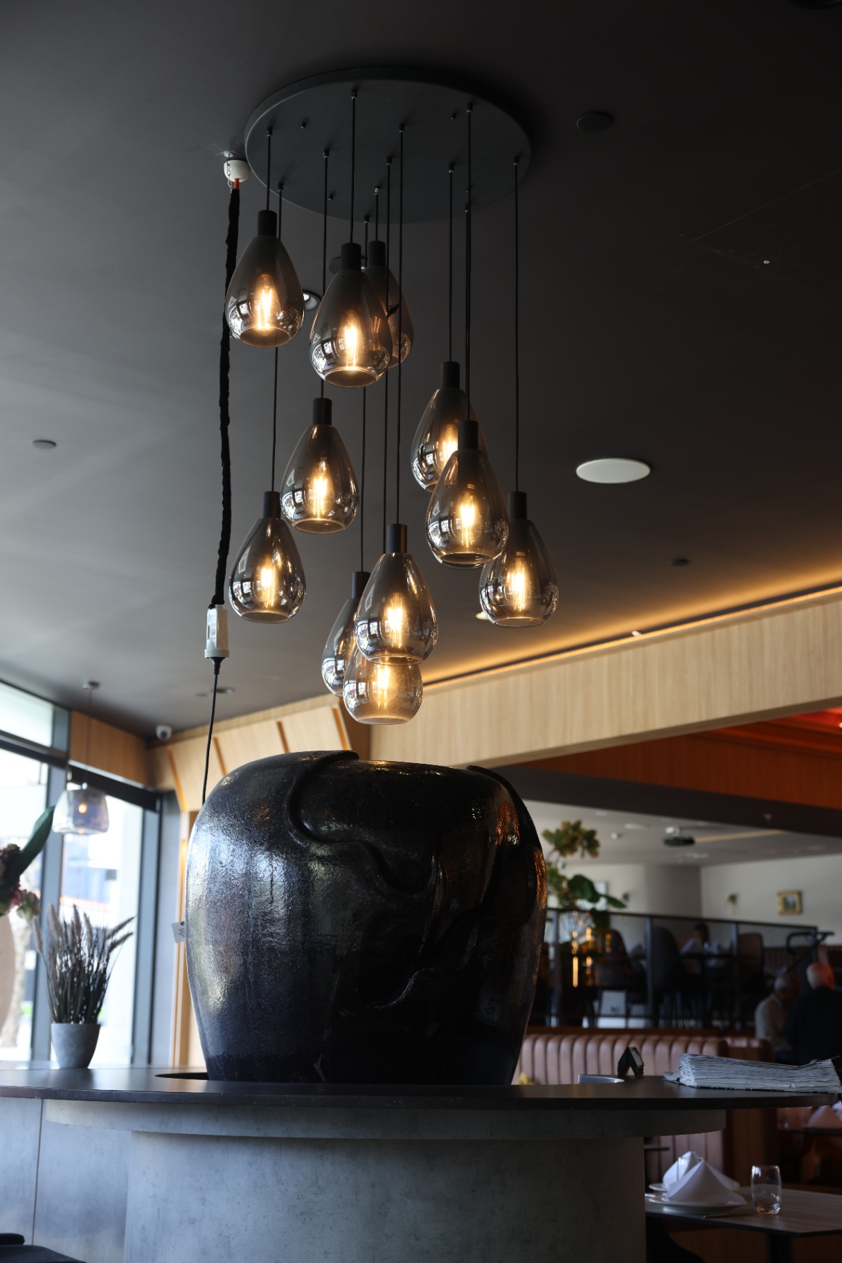 Teardrop pendant cluster above the ceramic urn