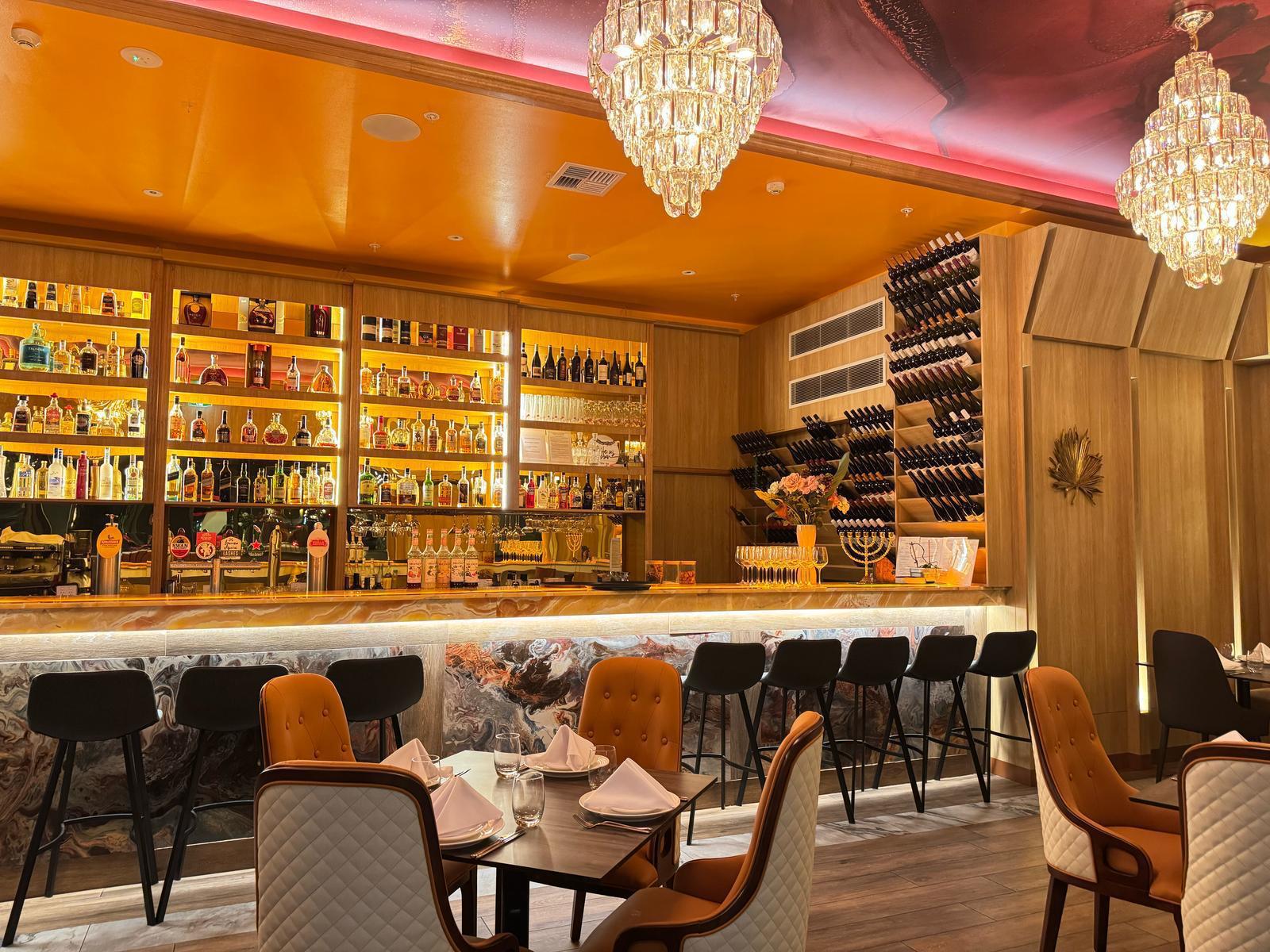 Bar lounge with marble counter and crystal chandeliers