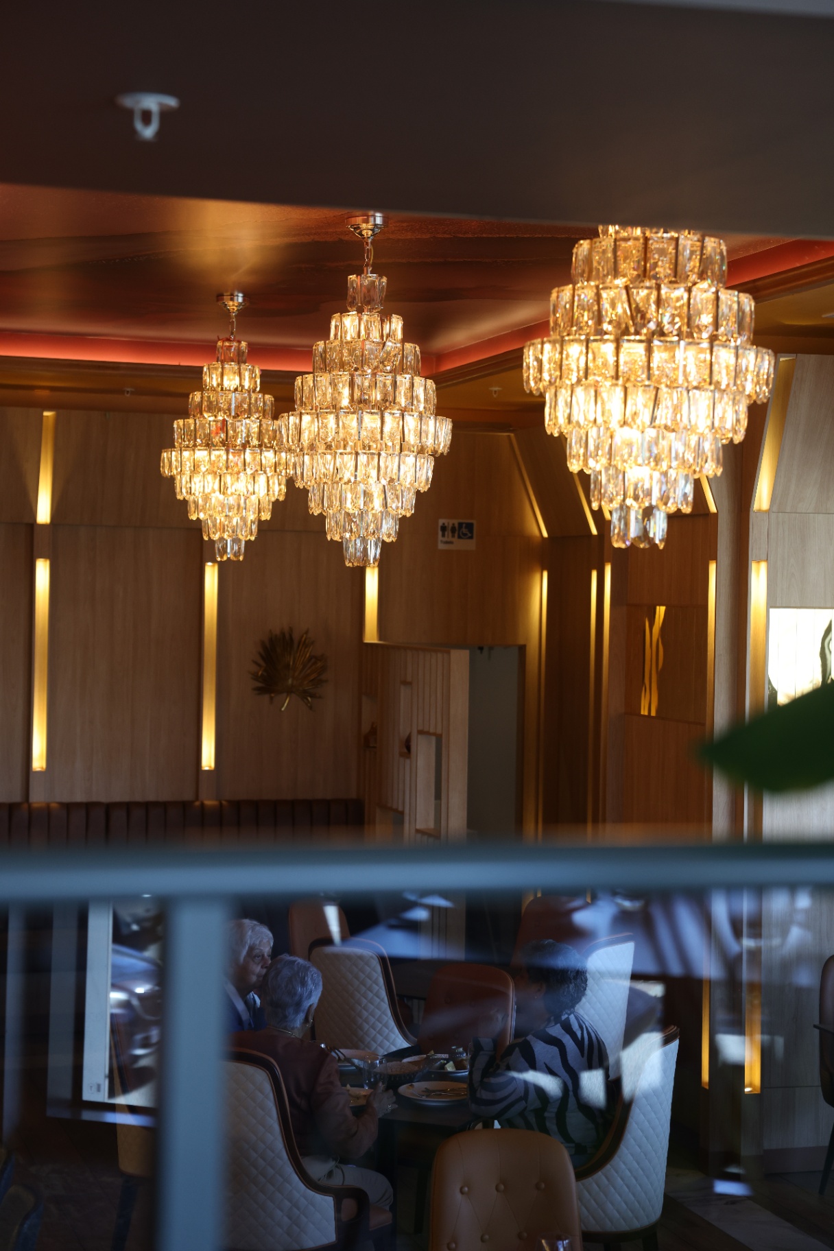 Crystal chandeliers glowing above the dining room